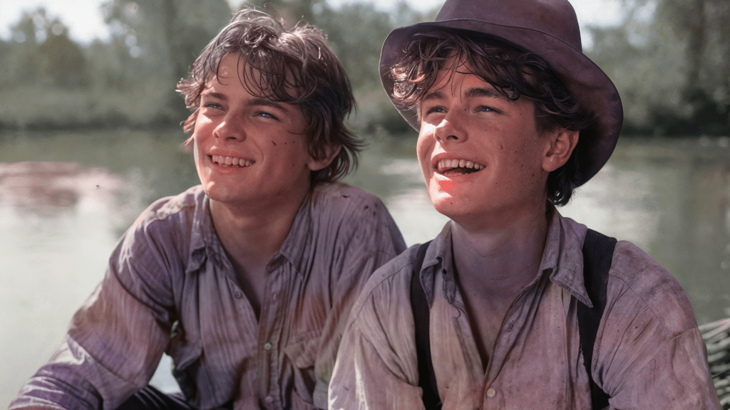 Tom Sawyer and Huck Finn share carefree laughs by the riverside, exuding youthful adventure. Budhiraja Official Podcast